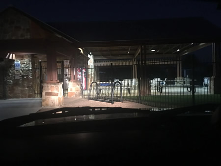 Patrol vehicle monitoring a retail center parking lot at dusk in san antonio